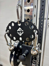 Load image into Gallery viewer, Black multi-tool with carabiners attached to a metal rack.
